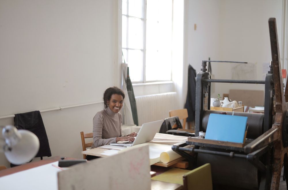 Business owner working through paperwork at a desk in her workshop